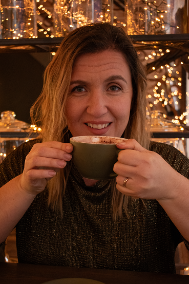Clair Carrington, Business & Visibility Strategist, enjoying a coffee